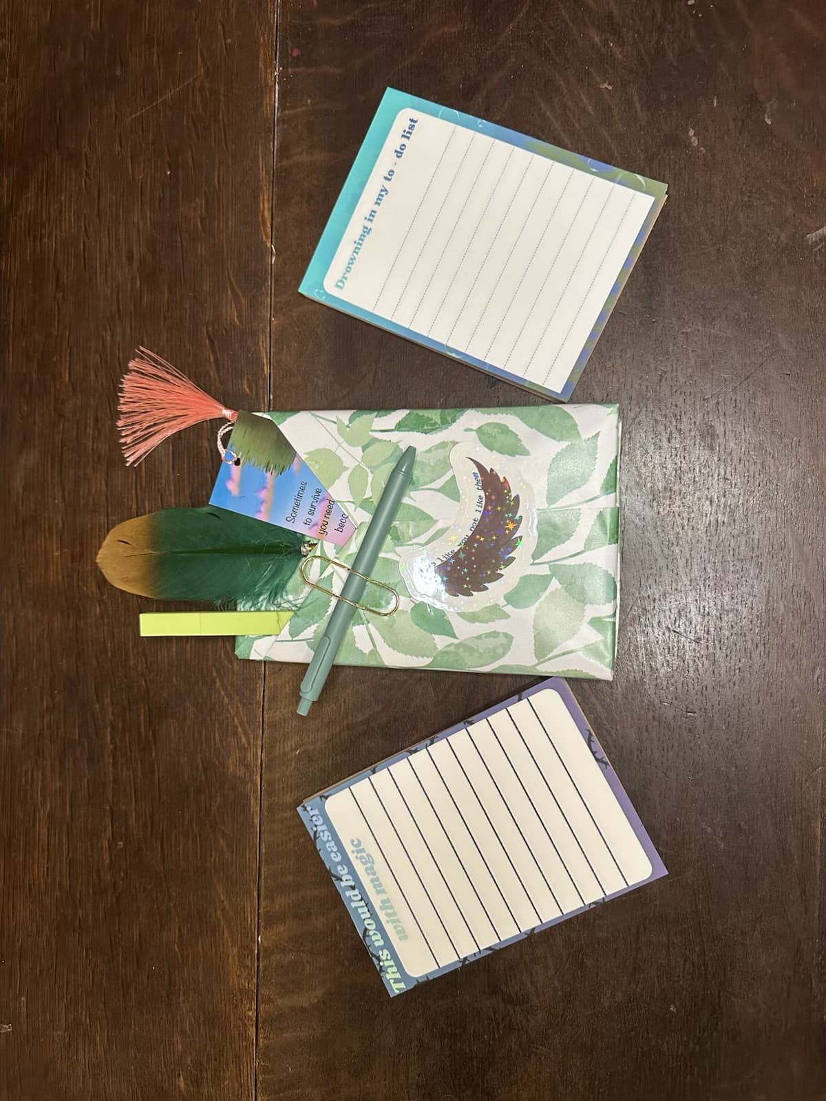 Petty Pixie Paper holographic stickers arranged on a dark wood table